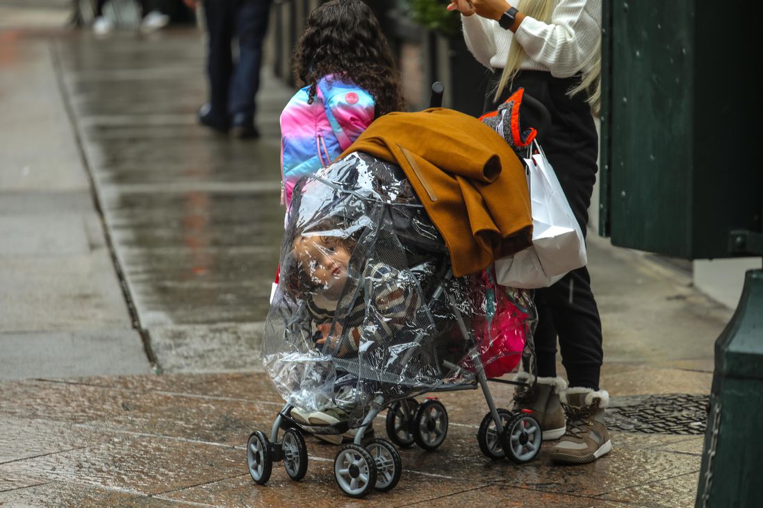 A child in a stroller watches